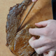 hand and knife slicing steak